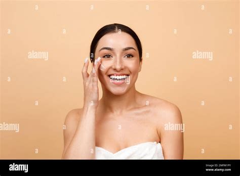 Skincare Routine Happy Young Indian Woman Applying Moisturizing Cream