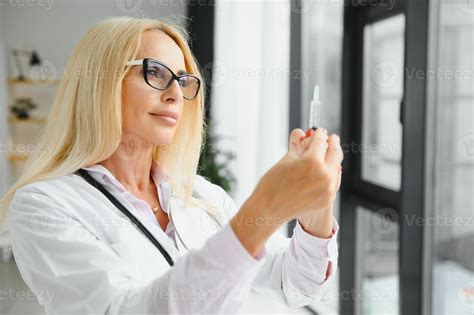 Portrait Of Middle Age Female Doctor Is Wearing A White Doctor S Coat With A Stethoscope Around