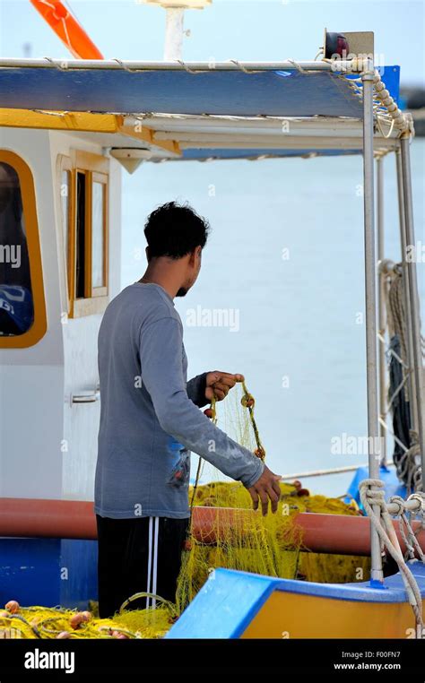 A Fisherman Tending To His Nets Santorini Greece Stock Photo Alamy