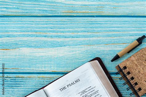 Psalms Open Holy Bible Book On A Blue Wooden Background With A Notebook