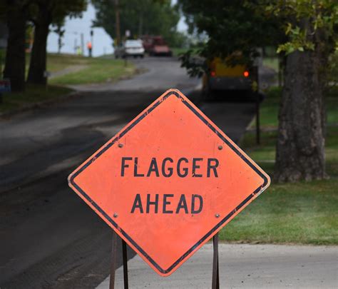 Download free photo of Flagger,construction,road,safety,sign - from ...