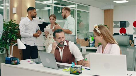 A Nice Handsome Boss Man Is Talking To His Beautiful Blonde Colleague