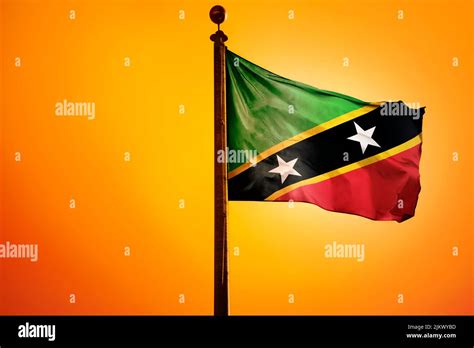 The National Flag Of Saint Kitts And Nevis On A Flagpole Isolated On An