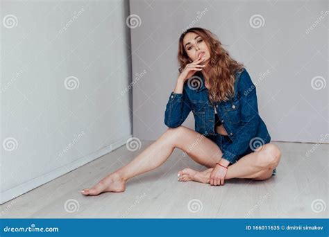 Portrait Of A Beautiful Fashionable Woman In Lingerie And Denim Shorts