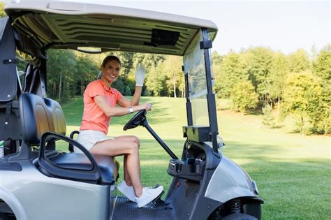Premium Photo Blonde Woman Maneuvering Golf Cart On Course