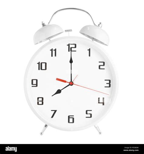 White alarm clock showing eight o'clock isolated on white background ...