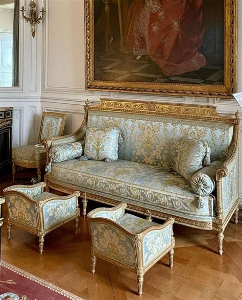 An Ornately Decorated Living Room With Couches And Chairs In Front Of A