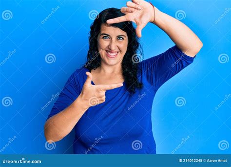 Plus Size Brunette Woman Wearing Casual Blue Shirt Smiling Making Frame With Hands And Fingers
