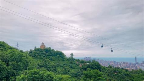 Ropeway Cable Car Cabins Silhouettes Are Moving Against Gray Sky In