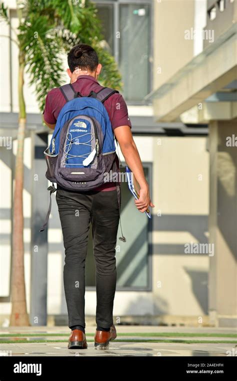 An University Student Walking With Backpack Stock Photo - Alamy