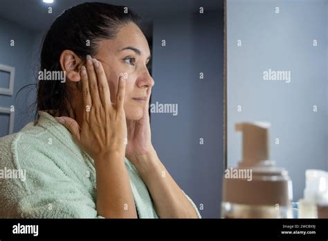 Natural Latina Woman In Front Of The Dressing Table Looking At Her Face Stock Photo Alamy
