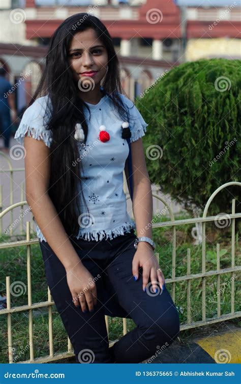 Portrait Of Indian Girl Wearing A Blue Western Dress And Watch In Hand