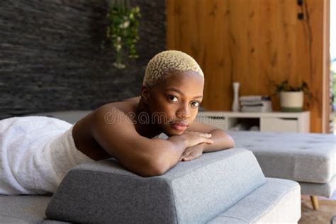 Portrait Of Happy African American Woman Wearing Towel And Lying On Bed