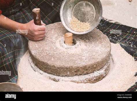 The Ancient Hand Mill Or Quern Stone Grinds The Grain Into Flour Old