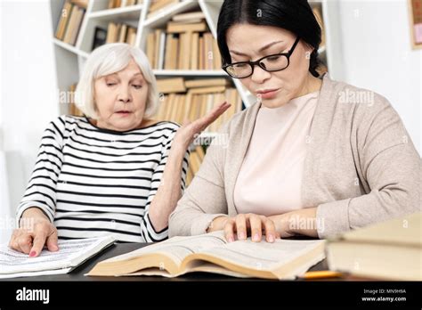 Shocked Mature Tutor Overlooking Her Student Stock Photo Alamy