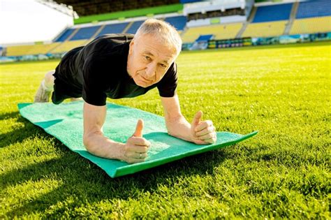 Premium Photo A Man Doing Push Ups On A Green Mat With The Word