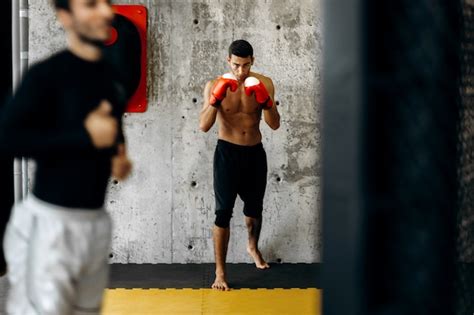 Premium Photo Brutal Dark Haired Guy With A Naked Torso And The Red Boxing Gloves Stands