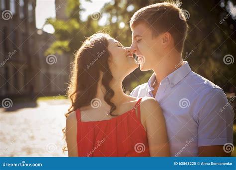 Beautiful Brunette Couple In Love Kissing On A Date In The Park Stock Image Image Of Happy