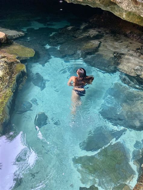 A Woman Is Swimming In The Clear Blue Water