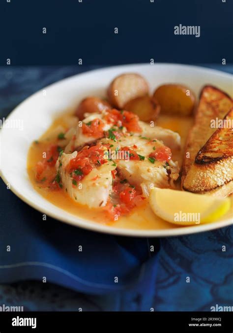 Poached Fish With Potatoes Stock Photo Alamy