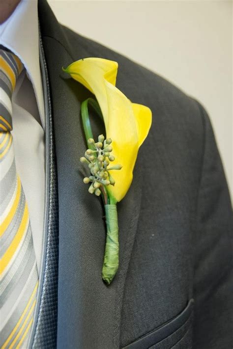 A Boutonniere With A Yellow Flower Attached To It S Lapel