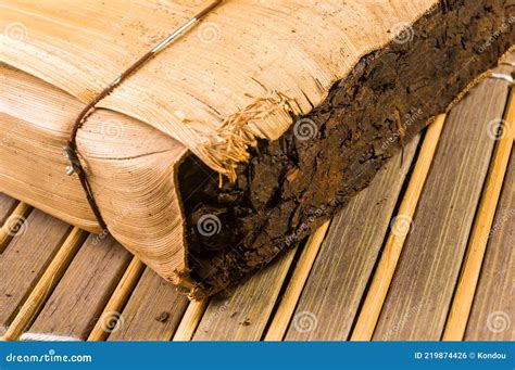 Chinese Pressed PU Erh Tea In Bamboo Leaf Packaging On A Bamboo Mat