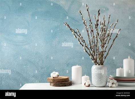 Composition With Pussy Willow Branches On White Wood Table Against Blue Background Stock Photo