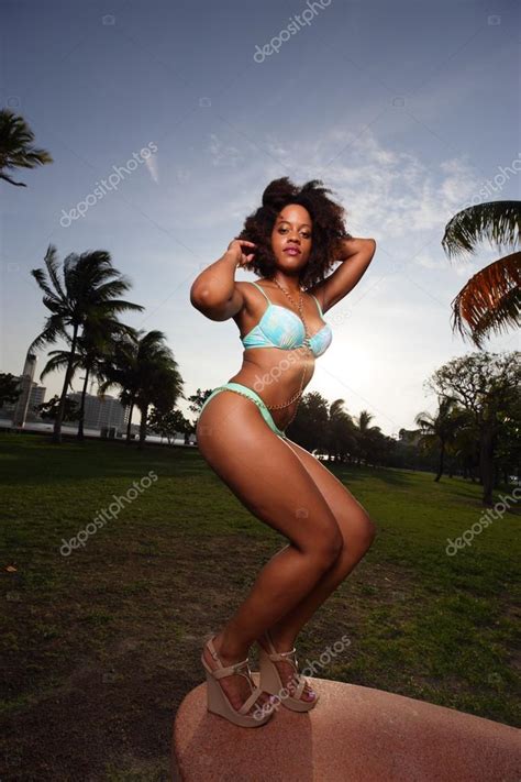 Woman Posing On A Lounge Chair In A Bikini Backlit By The Sunset