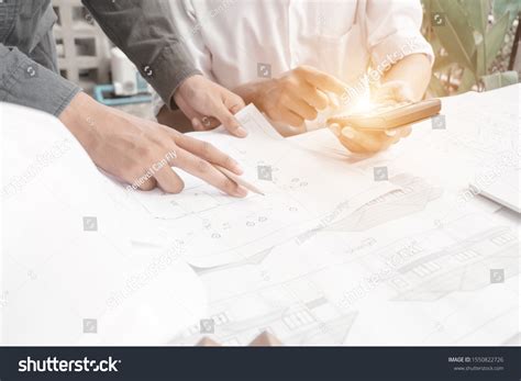 Engineers Pointing Building On Blueprint Drawing Stock Photo 1550822726