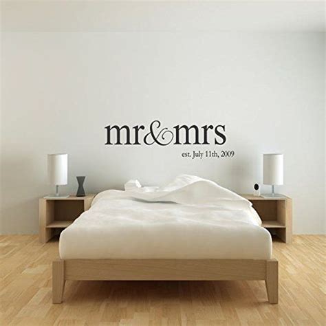 A Bedroom With A Bed Nightstands And Wall Decal That Says Mr Mrs