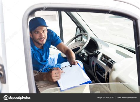 Delivery Man With Clipboard Stock Photo Igorvetushko