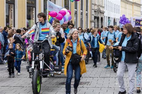 Man On A Bike With Rainbow Balloons Attending The Gay Pride Parade Also Known As