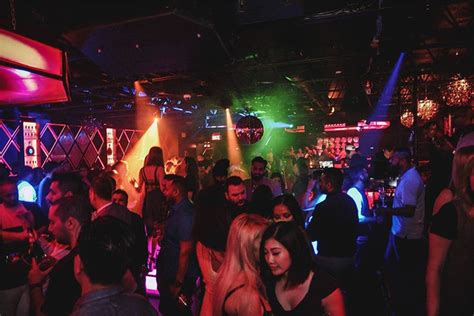 A Group Of People Standing Around At A Nightclub