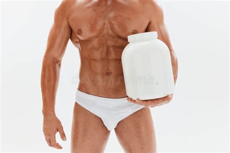 Man Bodybuilder Boxer With Naked Torso With Abs Holding A Can Of Muscle Growth Pills Steroids