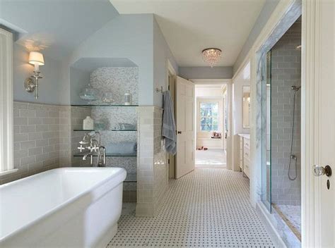 A White Bath Tub Sitting Inside Of A Bathroom Next To A Walk In Shower