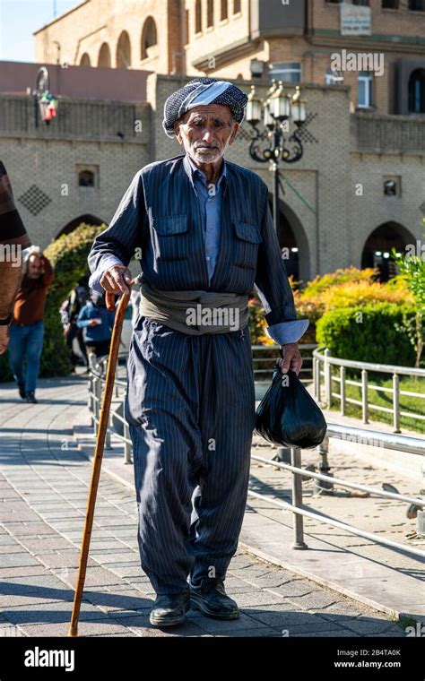 Kurdish man in traditional clothing is walking in Erbil near the Shar ...