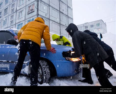 Pushing car in snow hi-res stock photography and images - Alamy