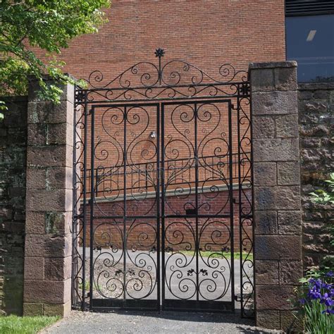 The Fence Has a Black Metal Gate for Security. Stock Image - Image of ...