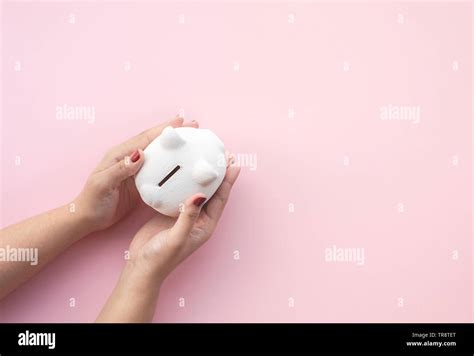 Female Holding Piggy Bank On Pastel Color Background Savings And