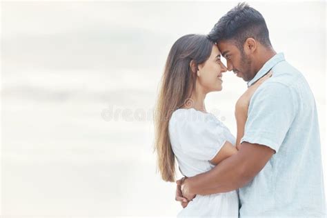 Date Love And Couple At The Beach Hug Look In Eyes And Bonding