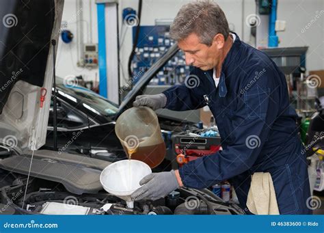 Mechanic Pouring Oil In Car Engine Stock Photo Image Of Mature