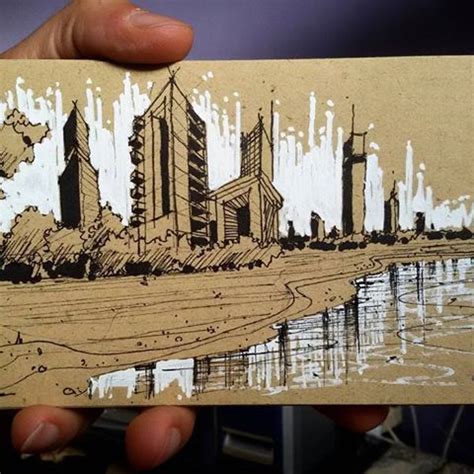 A Person Holding Up A Piece Of Paper With An Image Of A City On It