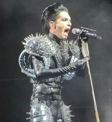 An Image Of A Man In Armor Singing Into A Microphone With Words Above