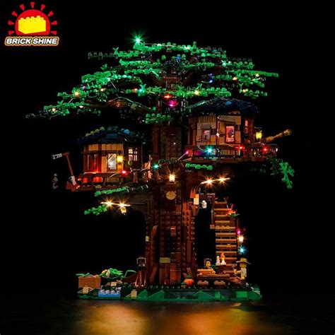 A Tree House Made Out Of Legos Is Lit Up With Lights And Trees On The Roof