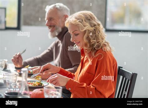 Mature Couple Sitting At The Table And Having Dinner Stock Photo Alamy