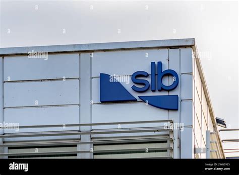 Sign and logo on a building of SLB, formerly Schlumberger. SLB is a ...