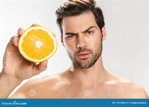 Photo Of Confused Half Naked Man Looking At Camera And Holding Orange Stock Image Image Of