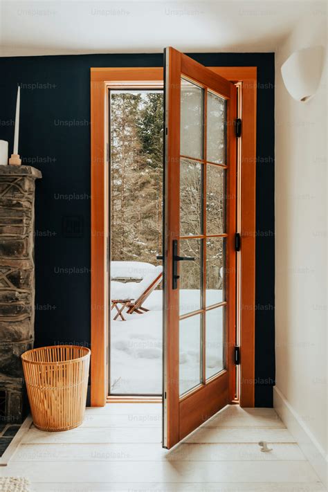 A living room with a fireplace and a large glass door photo – Back door