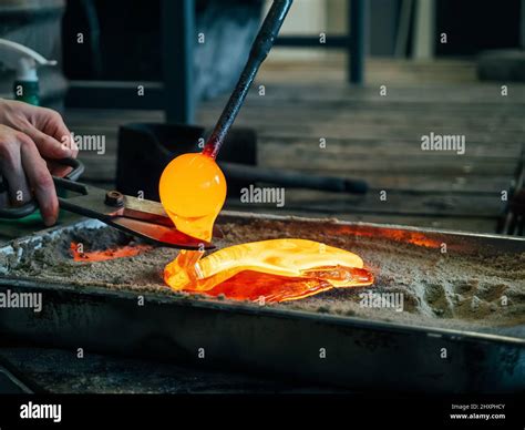 Creating traditional glass Art. Glass melting in a traditional oven of a glassblower manufacture ...