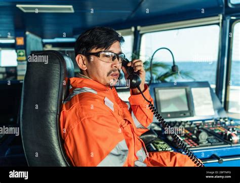 Filipino Deck Officer On Bridge Of Vessel Or Ship He Is Speaking On